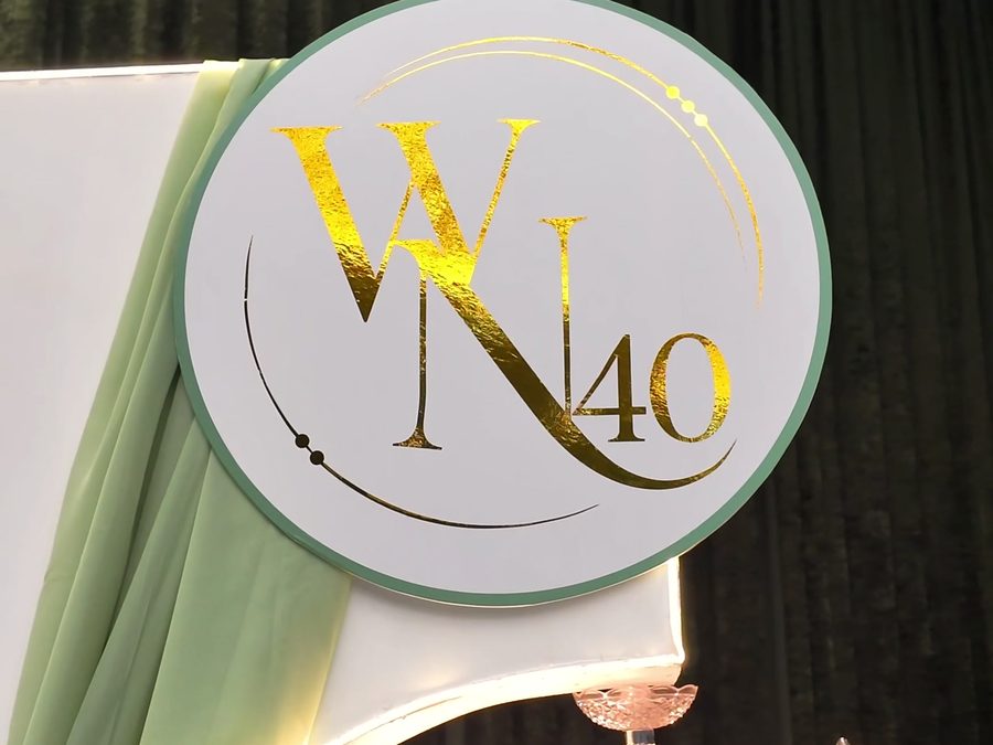 Gold W40 monogram beneath a crystal chandelier